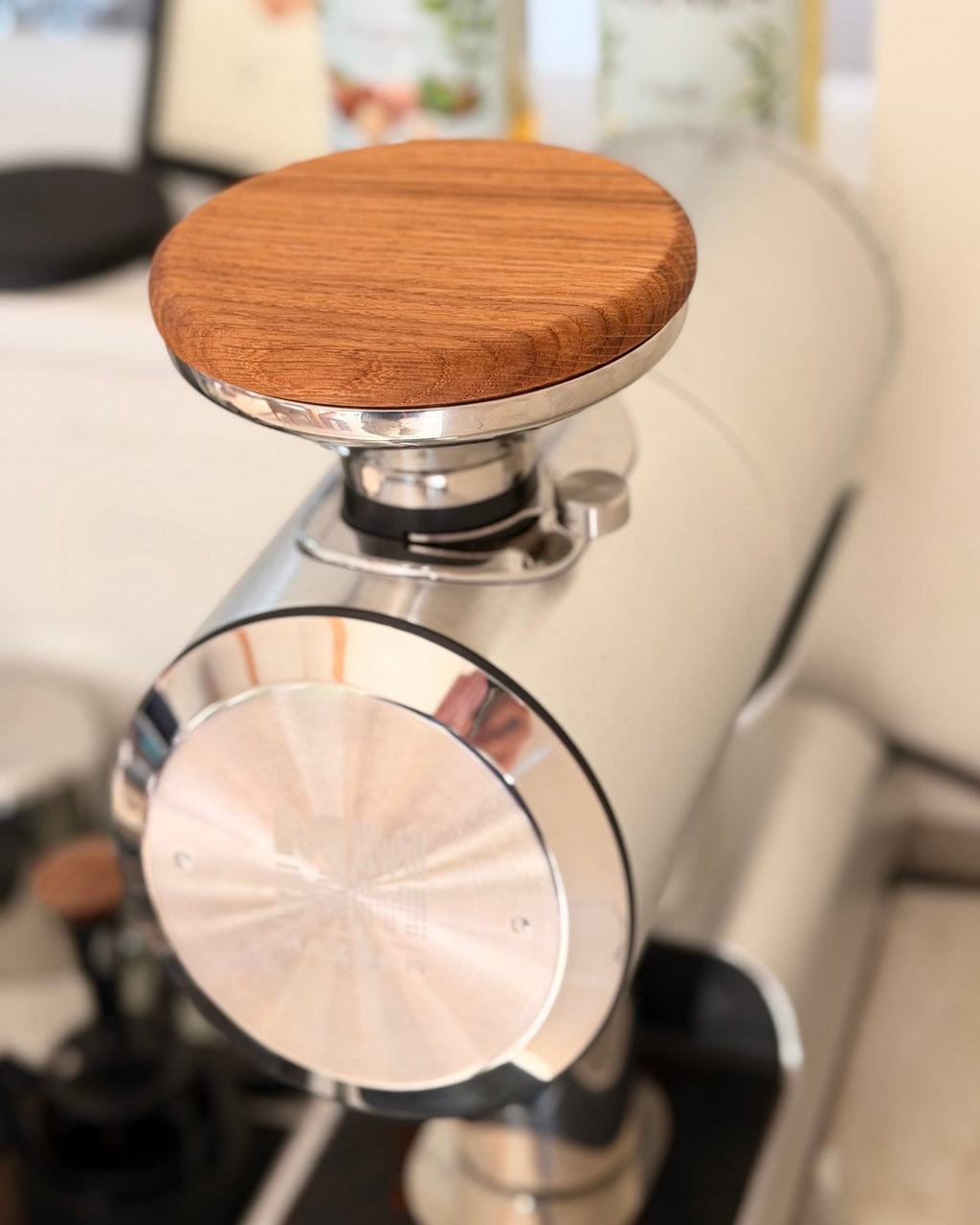Oak hopper lid on a Mazzer Philos grinder, seen from above and behind
