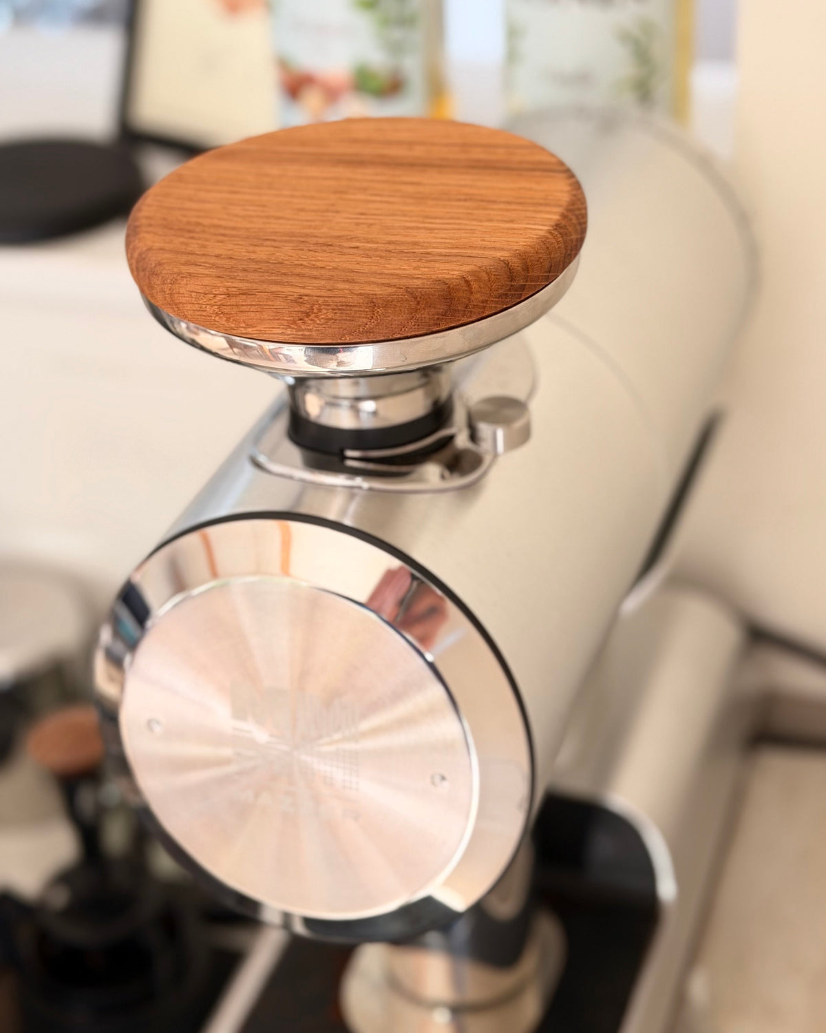 Oak hopper lid on a Mazzer Philos grinder, seen from above and behind